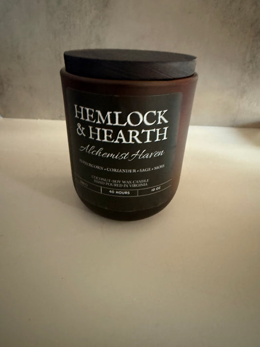 Candle with 'Hemlock & Hearth' label on a neutral background